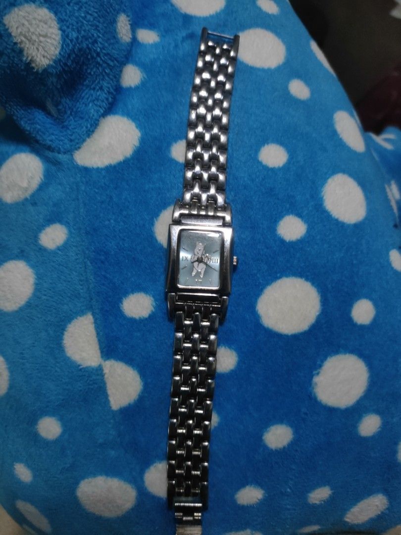 Disney Winnie the Pooh Silver Watch (Category: Women's Watches) located in Malolos. Submitted by kabanbags (Listing ID 1469185800, Image 1). Description: - Authentic Disney Winnie the Pooh collectible watch - Rectangular silver-tone dial with cute Pooh graphic - Elegant Roman numerals at 3, 6, 9, and 12 o'clock - Durable metal link bracelet with clean metallic finish - Stainless steel back case - Reliable battery-powered quartz movement - Great f