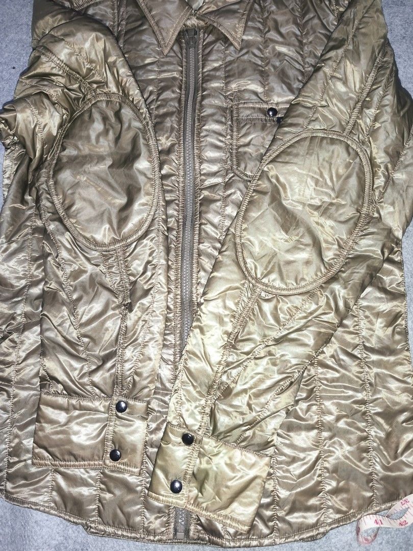 Dolce & Gabbana Quilted Jacket (Category: Luxury Apparel) located in Cagayan de Oro. Submitted by adamfitz (Listing ID 1469383415, Image 3). Description: Dolce & Gabbana quilted jacket in olive tone. Full zip front with button-closure chest pockets and reinforced elbow patches. Classic collar design and button cuffs. Branded label patch on the front pocket. Silky textured fabric with vertical stitching pattern all over. 19.5x27 excellent no issue