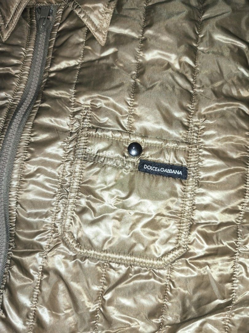Dolce & Gabbana Quilted Jacket (Category: Luxury Apparel) located in Cagayan de Oro. Submitted by adamfitz (Listing ID 1469383415, Image 2). Description: Dolce & Gabbana quilted jacket in olive tone. Full zip front with button-closure chest pockets and reinforced elbow patches. Classic collar design and button cuffs. Branded label patch on the front pocket. Silky textured fabric with vertical stitching pattern all over. 19.5x27 excellent no issue