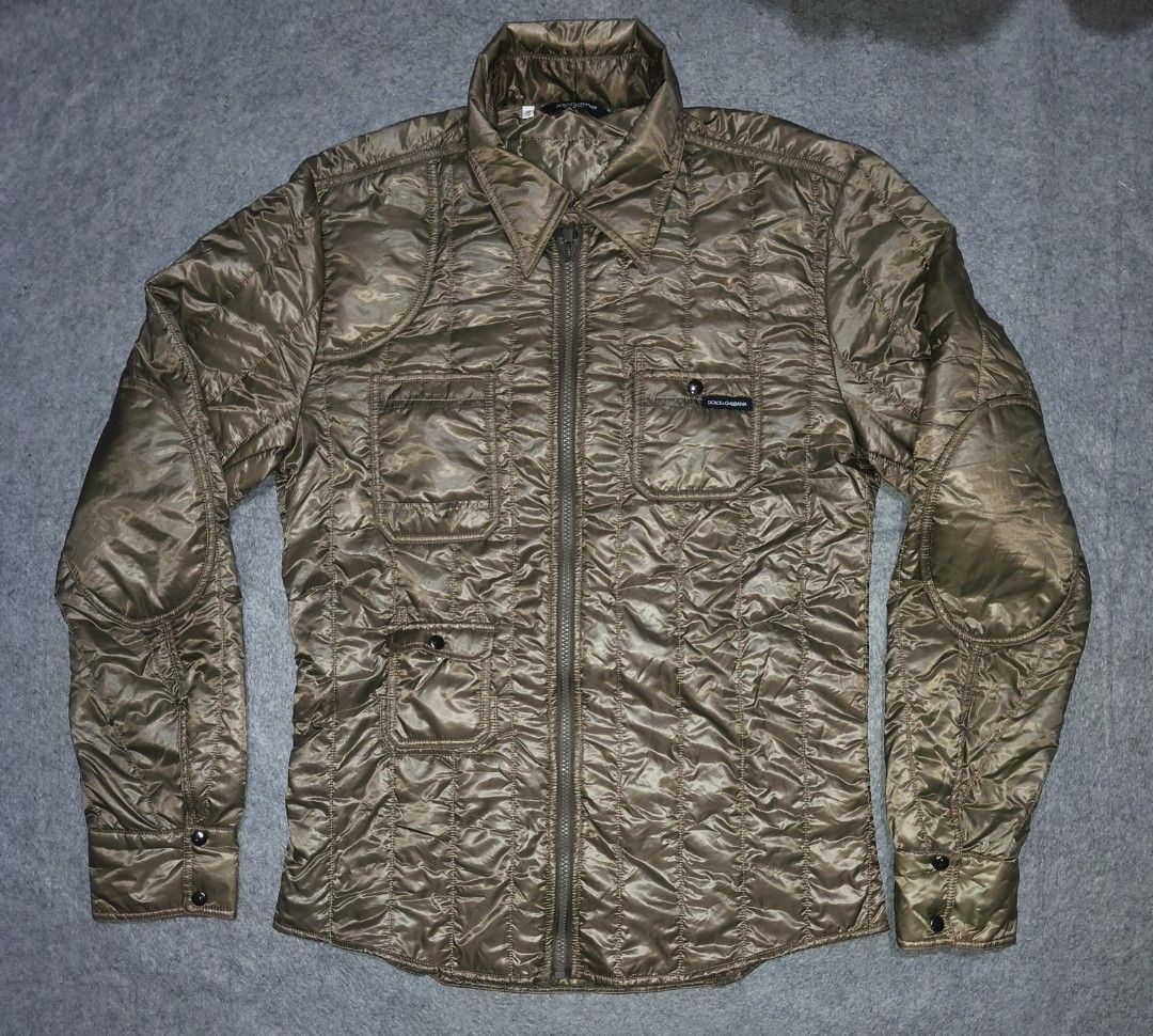 Dolce & Gabbana Quilted Jacket (Category: Luxury Apparel) located in Cagayan de Oro. Submitted by adamfitz (Listing ID 1469383415, Image 1). Description: Dolce & Gabbana quilted jacket in olive tone. Full zip front with button-closure chest pockets and reinforced elbow patches. Classic collar design and button cuffs. Branded label patch on the front pocket. Silky textured fabric with vertical stitching pattern all over. 19.5x27 excellent no issue