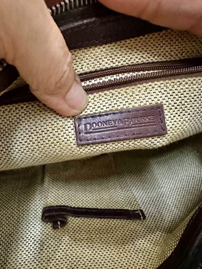 Dooney & Bourke Monogram Shoulder Bag (Category: Luxury Bags & Wallets) located in Santiago. Submitted by evrythngulove (Listing ID 1469334089, Image 3). Description: Authentic Dooney & Bourke shoulder bag in classic beige and brown monogram with dark brown leather trim. Features a top zip closure, clean interior with pockets, and a key keeper strap. Perfect for everyday use!.
