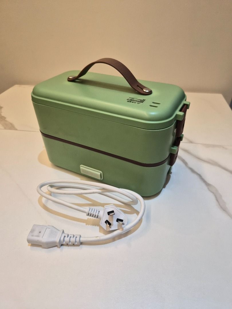 Double-Layer Electric Lunch Box steamer can cook rice (Category: Food Organization & Storage) located in Mandaluyong City. Submitted by buymekatey (Listing ID 1469285685, Image 1). Description: - Color: Green with brown handle and side latches - Material: Stainless steel inner trays - Design: 2 tiers with multi-compartment interior to keep food separate - Usage: Portable electric food warmer for office, school, or travel - Inclusion: Power cord w