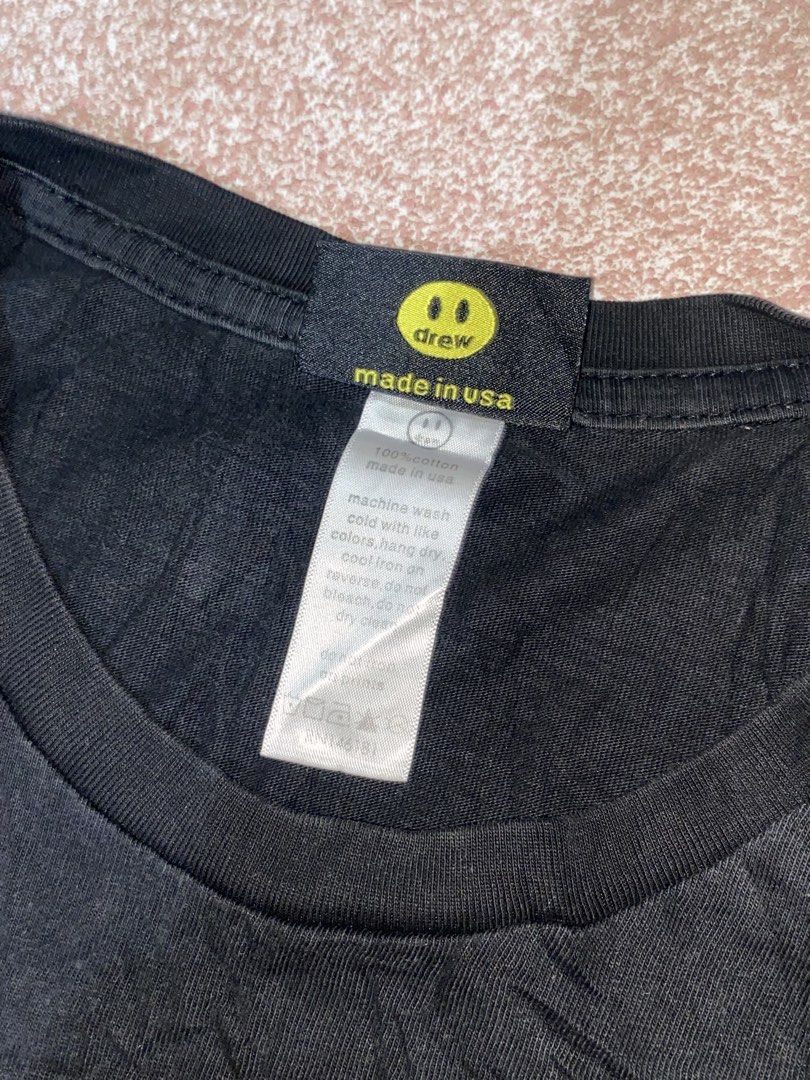 Drew House Black Graphic Tee Size L (Category: Tshirts & Polo Shirts ) located in Talisay. Submitted by rjthriftfinds (Listing ID 1469282064, Image 3). Description: Color may vary due to lighting fit. To med-large 9.5/10 color rate need wash - Brand: Drew House - Color: Black - Size: Large - Material: 100% Cotton, Made in USA - Design: Iconic stylized face graphic on front - Details: Classic crew neck, short sleeves, with original interior neck t