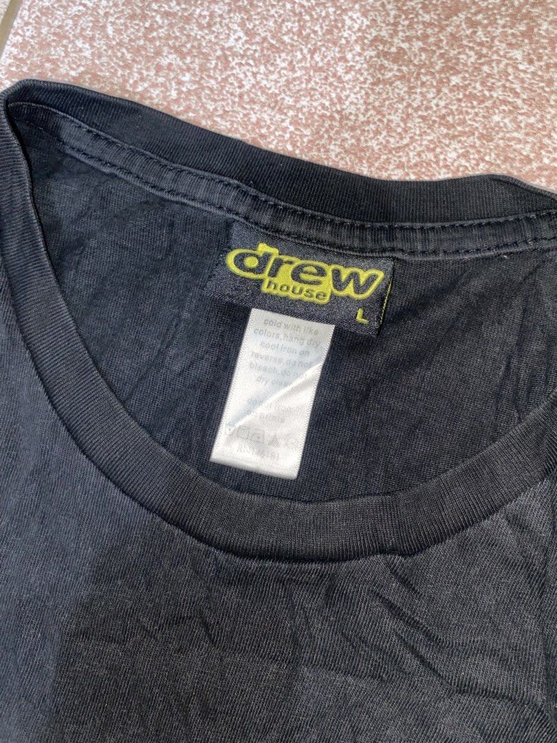 Drew House Black Graphic Tee Size L (Category: Tshirts & Polo Shirts ) located in Talisay. Submitted by rjthriftfinds (Listing ID 1469282064, Image 2). Description: Color may vary due to lighting fit. To med-large 9.5/10 color rate need wash - Brand: Drew House - Color: Black - Size: Large - Material: 100% Cotton, Made in USA - Design: Iconic stylized face graphic on front - Details: Classic crew neck, short sleeves, with original interior neck t