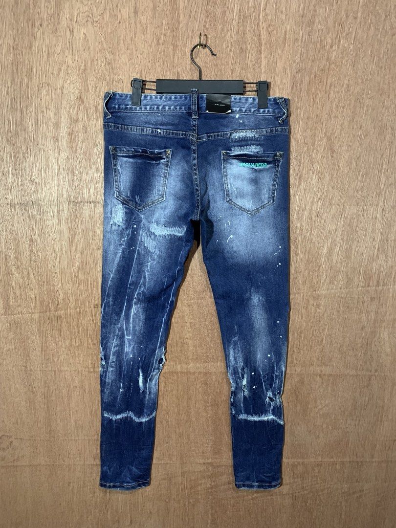 DSQUARED2 Slim Jean Distressed Denim Size 38 (Category: Jeans) located in Tacurong. Submitted by ljsthrift (Listing ID 1469176724, Image 1). Description: - Brand: DSQUARED2 (Made in Italy by Staff International) - Style: Slim fit denim jeans in dark blue wash - Size: 29-30 - Details: Distressed finish with unique paint splatter effects and button fly closure - Signature feature: Green DSQUARED2 embroidery on the back pocket.