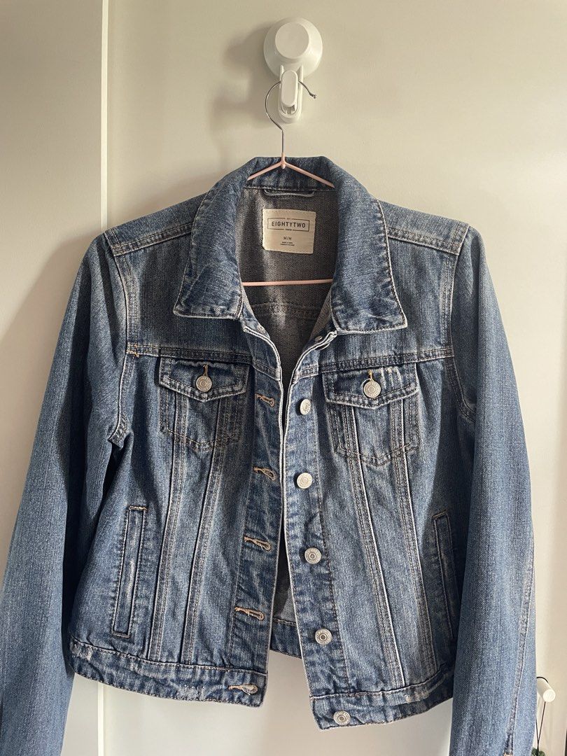 EightyTwo Denim Jacket Blue Size M (Category: Coats, Jackets and Outerwear) located in Agdangan. Submitted by happyphoenix.d92869 (Listing ID 1469215751, Image 1). Description: - Brand: EightyTwo - Style: Classic denim jacket - Color: Medium wash blue with contrast stitching - Size: Medium (M) - Features: Metal button closures, standard collar, fitted hem, two chest flap pockets, and two side pockets - Condition: Clean interior lining, great for 