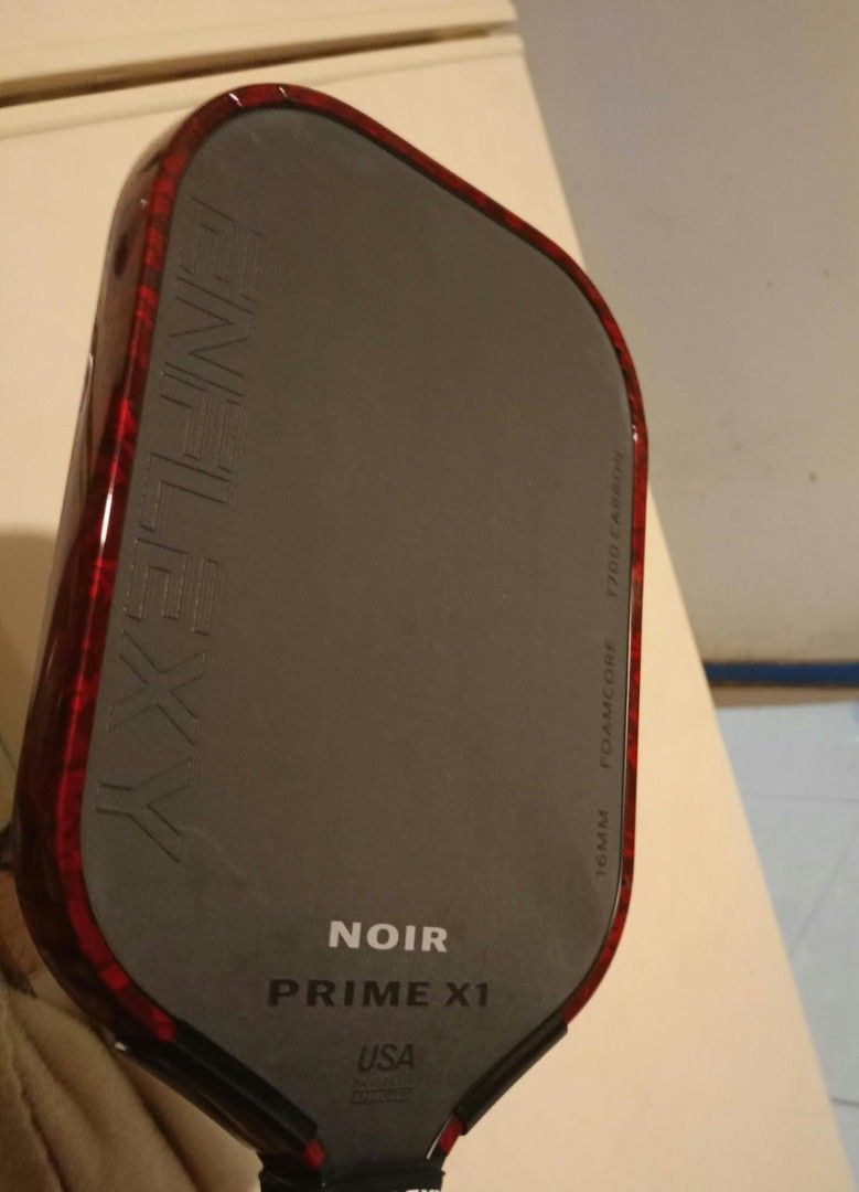 Enflexy Noir Prime X1 16mm Pickleball Paddle (Category: Racket and Ball Sports) located in Davao. Submitted by katy.tx (Listing ID 1469373313, Image 2). Description: - Model: Enflexy Noir Prime X1 Pickleball Paddle - Colorway: Red and black edge guard - Thickness: 16mm for optimal control and power - Surface: T700 carbon fiber for superior spin - Core: Foam core construction - Certification: USA Pickleball (USAPA) approved - Inclusions: Original 