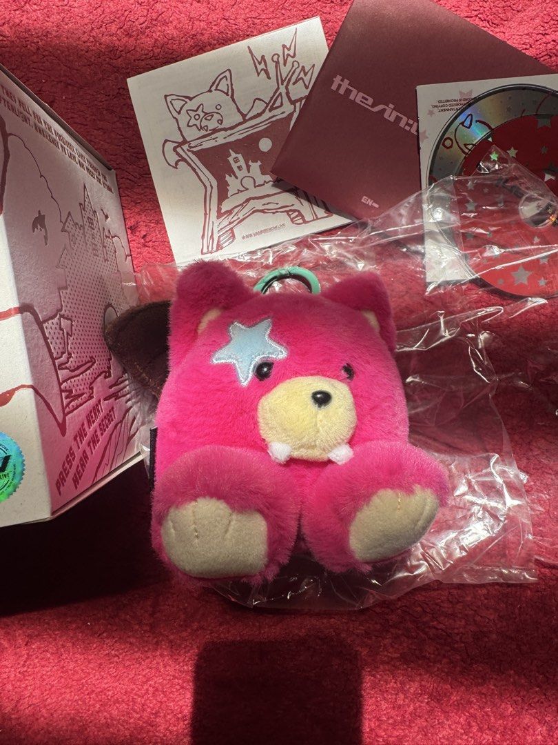 Enhypen Vampire Jake Voice Keyring (Category: Plushies & Soft Toys) located in Pasay City. Submitted by michmonteros (Listing ID 1469366103, Image 1). Description: - Official ENHYPEN merch bundle - Includes pink vampire bear plush keychain (clean fur, blue star patch, tiny fangs) - Comes with matching graphic box (minor edge wear) - Includes lyric sheet, dark red album sleeve, and CD - Working Voice Record by Jake.