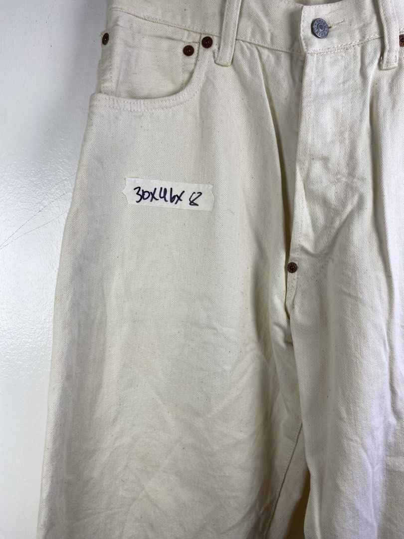 Evisu White Cotton Jeans Size 36 (Category: Jeans) located in Manila. Submitted by declutterpromax (Listing ID 1469201985, Image 2). Description: - Material: 100% cotton white denim - Size: 36 (inner waistband tag) - Fit: Straight leg style - Details: Unique curved back pockets, branded buttons, and thick contrast stitching - Condition: Pre-owned/storage item with some minor yellowing and spots.