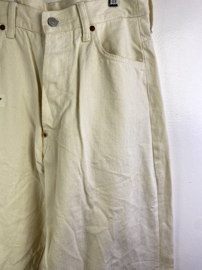 Evisu White Cotton Jeans Size 36 (Category: Jeans) located in Manila. Submitted by declutterpromax (Listing ID 1469201985, Image 3). Description: - Material: 100% cotton white denim - Size: 36 (inner waistband tag) - Fit: Straight leg style - Details: Unique curved back pockets, branded buttons, and thick contrast stitching - Condition: Pre-owned/storage item with some minor yellowing and spots.