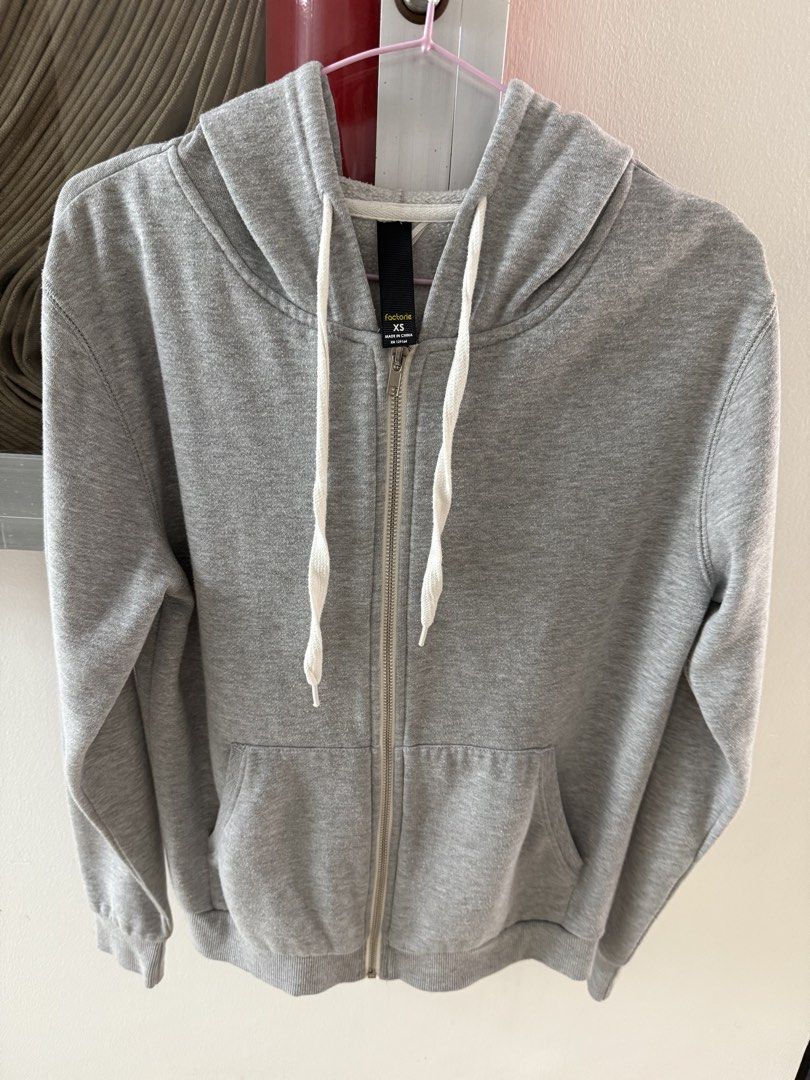 Factorie Grey Zip-Up Hoodie Size XS (Category: Coats, Jackets and Outerwear) located in Mandaluyong City. Submitted by declutteringmylife101 (Listing ID 1469169995, Image 1). Description: - Brand/Model: Factorie zip-up hoodie - Size: XS - Color: Grey with white drawstring cords - Pockets: Standard front pockets - Details: Ribbed cuffs and hem with clean fabric texture inside and out - Condition: Excellent, well-maintained.