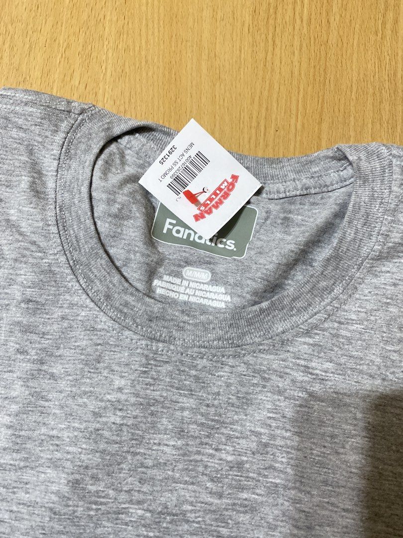 Fanatics Grey T-Shirt Size M (Category: Tshirts & Polo Shirts ) located in Batangas. Submitted by lux_kimmy (Listing ID 1469342136, Image 3). Description: - Brand: Fanatics - Condition: Brand new with tags (Forman Mills) - Size: Men's Medium (M) - Color: Heather Grey - Style: Short sleeve, crewneck, active tee - Material: Comfortable activewear fabric - Origin: Made in Nicaragua.