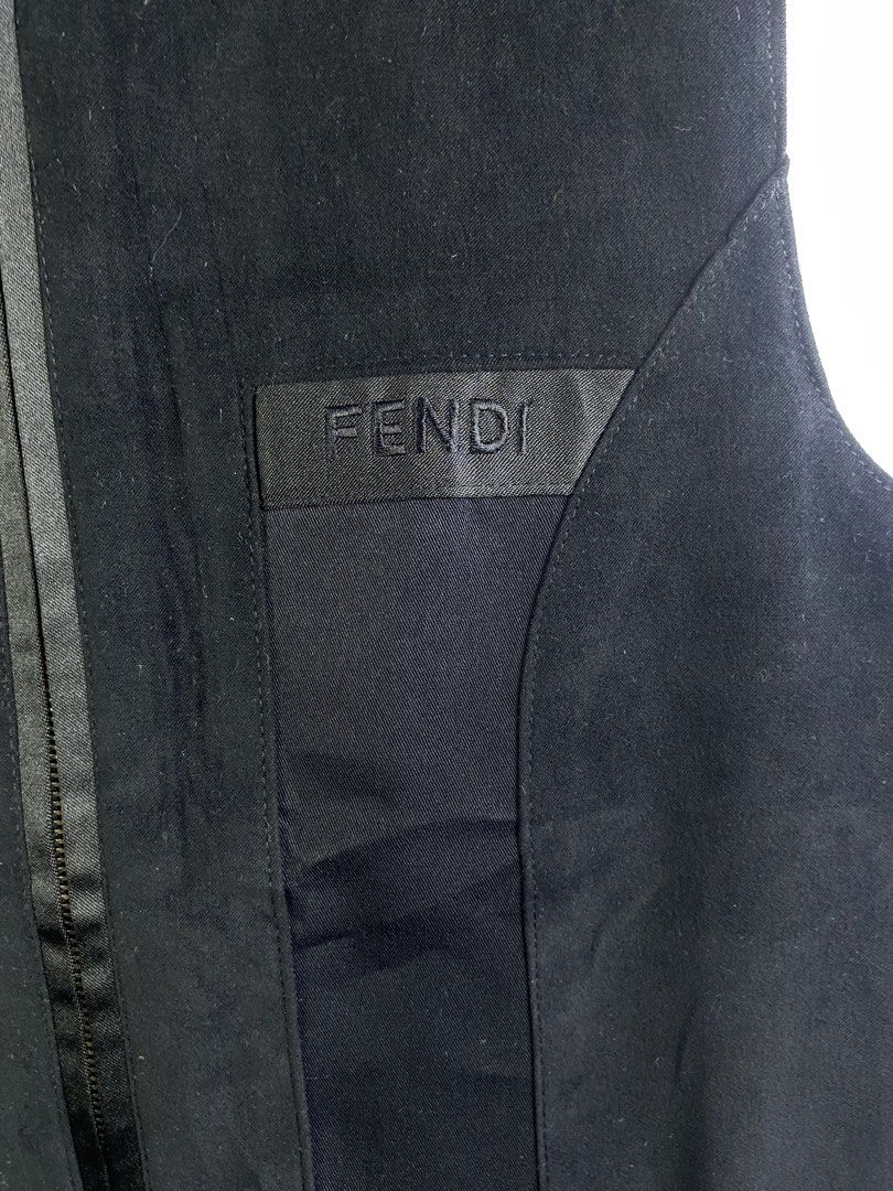 Fendi Jeans Black Zip-Up Vest Size M (Category: Sleeveless) located in Manila. Submitted by declutterpromax (Listing ID 1469202313, Image 3). Description: - Brand: Fendi Jeans - Style: Black zip-up vest with branded metal pull - Size: Medium (tag on collar) - Details: Embroidered Fendi logo, front patch pocket, two satin-trimmed front pockets - Origin: Made in Italy (Alias S.p.A. production) - Condition: Clean and classic design, ready to wear.