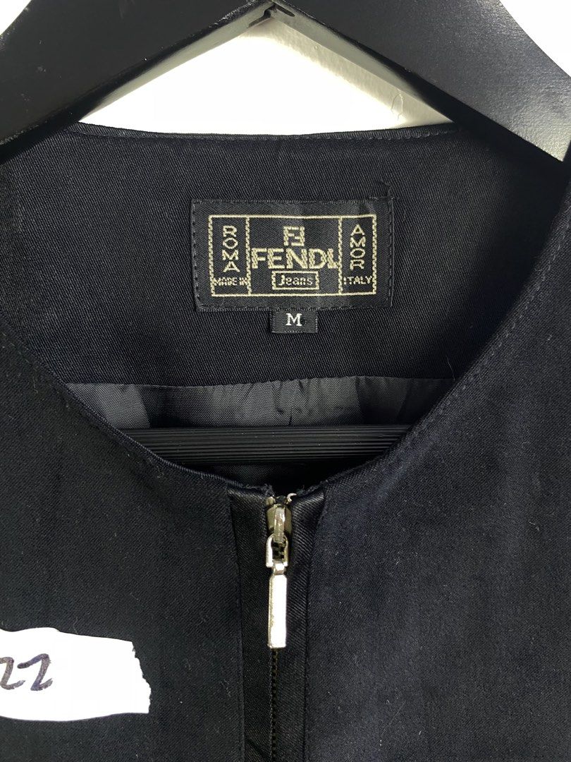 Fendi Jeans Black Zip-Up Vest Size M (Category: Sleeveless) located in Manila. Submitted by declutterpromax (Listing ID 1469202313, Image 2). Description: - Brand: Fendi Jeans - Style: Black zip-up vest with branded metal pull - Size: Medium (tag on collar) - Details: Embroidered Fendi logo, front patch pocket, two satin-trimmed front pockets - Origin: Made in Italy (Alias S.p.A. production) - Condition: Clean and classic design, ready to wear.