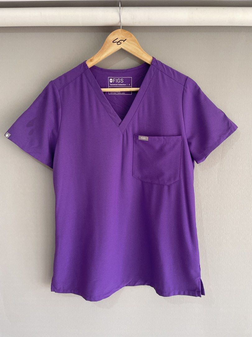 FIGS Technical Collection Purple Scrub Top Size S (Category: Activewear) located in Mataasnakahoy. Submitted by zero4thrift (Listing ID 1469202720, Image 1). Description: - Brand: FIGS Technical Collection - Size: Small - Color: Purple - Style: V-neck with single chest pocket - Material: 75% polyester, 19% rayon, 6% spandex - Condition: Brand new with tags attached - Origin: Made in Vietnam FIGS Catarina One-Pocket Scrub Top (Purple) Small size o