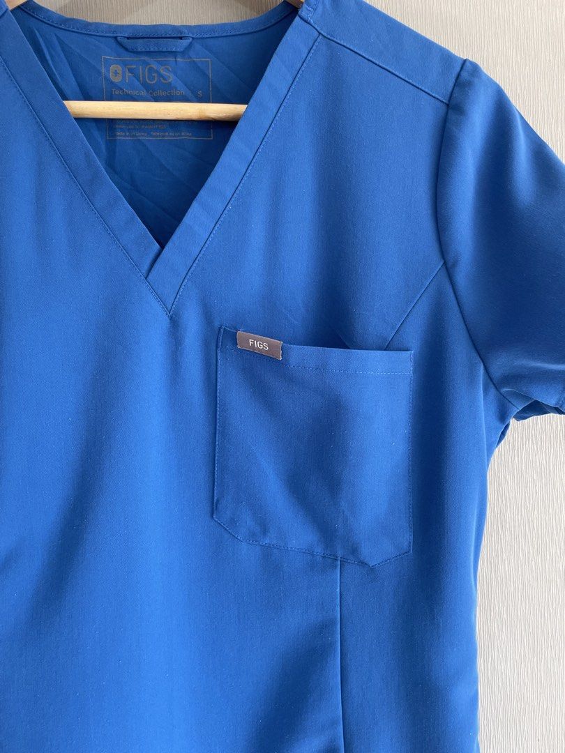 FIGS Technical Collection Scrub Top Royal Blue Size S (Category: Activewear) located in Mataasnakahoy. Submitted by zero4thrift (Listing ID 1469211971, Image 3). Description: - Brand/Collection: FIGS Technical Collection - Style Number: W22SW1014 - Color: Vibrant Royal Blue - Size: Small - Material: 72% Polyester, 21% Rayon, 7% Spandex - Features: Classic V-neck, single chest pocket with logo label, signature cross logo on the right sleeve - Cond