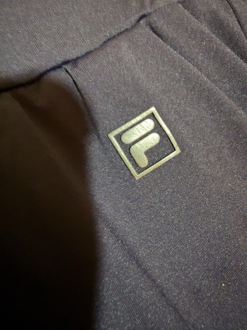 FILA Navy Blue Jogger Pants Size M (Category: Activewear) located in Siquijor. Submitted by yhostuff (Listing ID 1469181031, Image 3). Description: - Brand: FILA - Color: Navy Blue - Size: M (165/66A) - Waist: Elastic with branded FILA drawstrings - Details: Silver FILA logo badge on front left pocket - Pockets: Two side pockets included - Hem: Cuffed at the bottom - Style: Great for athletic or casual wear Waist: 28-30” Length:25”.