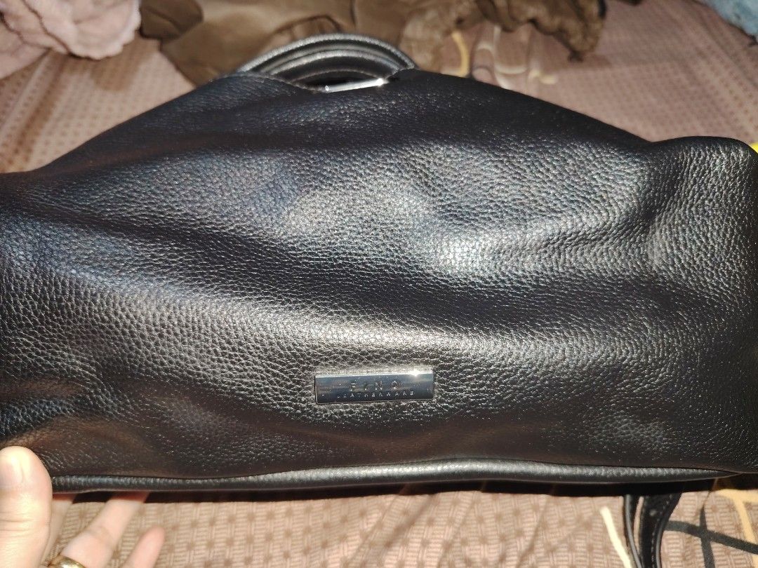 Fino Leatherware Black Pebble Leather Handbag (Category: Luxury Bags & Wallets) located in Valenzuela. Submitted by ryu12 (Listing ID 1469209242, Image 3). Description: - Brand: Fino Leatherware - Material: Premium black pebbled leather with silver-tone hardware - Design: Structured shape with strap buckle closure and brand plaque on base - Versatility: Includes double top handles and a detachable long shoulder strap - Functionality: Roomy interi