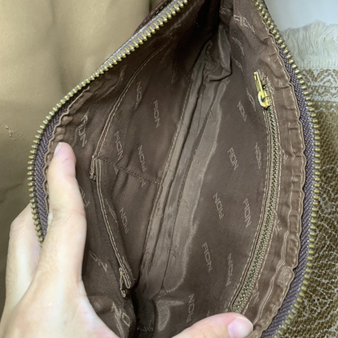 FION Monogram Brown Shoulder Bag (Category: Luxury Bags & Wallets) located in Mandaluyong City. Submitted by gentle.segoviajam (Listing ID 1469322996, Image 2). Description: Authentic FION brown monogram shoulder bag with tan leather trim. Features a secure zip top, fabric-lined interior with pockets, and minor hardware tarnishing. Perfect everyday compact bag!.