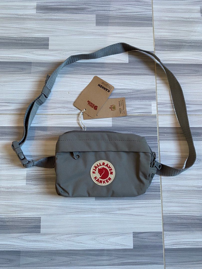 Fjallraven Kanken Hip Pack Sling Bag (Category: Cross-body Bags) located in Bayambang. Submitted by vintagestuffph (Listing ID 1469198863, Image 1). Description: - Authentic grey Fjallraven Kanken sling bag - Original tags still attached - Adjustable strap with secure buckle closure - Convenient front zip pocket - Spacious main compartment with interior slip pocket and key hook.