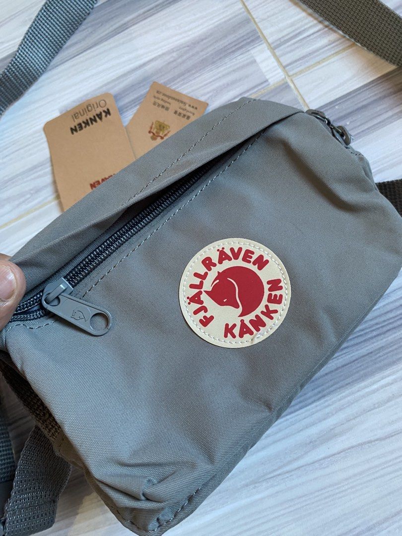 Fjallraven Kanken Hip Pack Sling Bag (Category: Cross-body Bags) located in Bayambang. Submitted by vintagestuffph (Listing ID 1469198863, Image 2). Description: - Authentic grey Fjallraven Kanken sling bag - Original tags still attached - Adjustable strap with secure buckle closure - Convenient front zip pocket - Spacious main compartment with interior slip pocket and key hook.