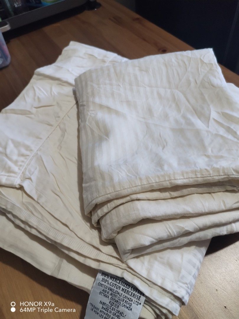 Flatsheet & Pillow case ( King size) (Category: Bedding & Towels) located in Muntinlupa City. Submitted by arciagamaryann68 (Listing ID 1469217934, Image 1). Description: - Product: Flatsheet & Pillow Case Set - Material: 100% Mercerized Cotton (imported from Costco Wholesale Canada) - Color/Design: Cream / Off-white with subtle stripe pattern - Condition: Well-maintained, clean, and gently used - Features: Soft, breathable, hotel-quality fabric 