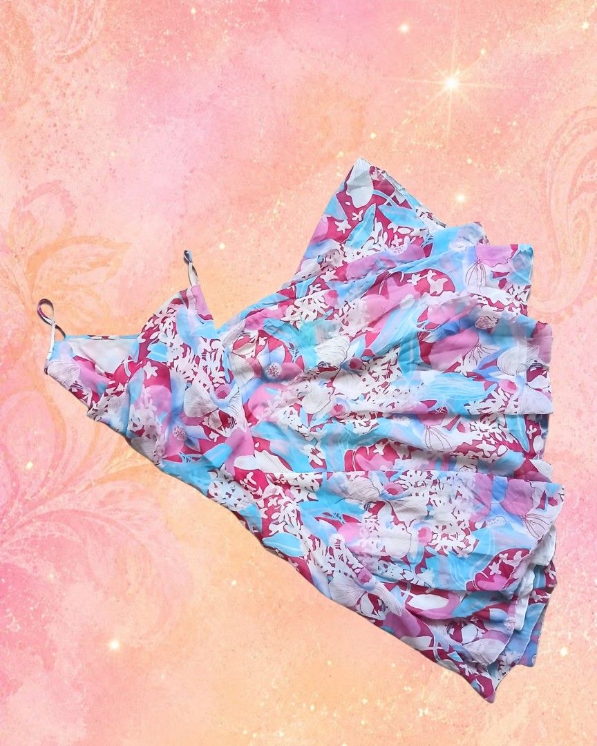 Floral spaghetti strap bias dress (Category: Dresses) located in Antipolo. Submitted by mochisky (Listing ID 1469227239, Image 1). Description: - Style: Flowy floral dress with a draped cowl neckline and flared skater skirt - Colors: Vibrant shades of pink, blue, and white - Details: Thin spaghetti straps, lightweight fabric, all-over pattern - Size: Fits extra small to small frames easily - Perfect for: Warm days, casual outings, and dates.