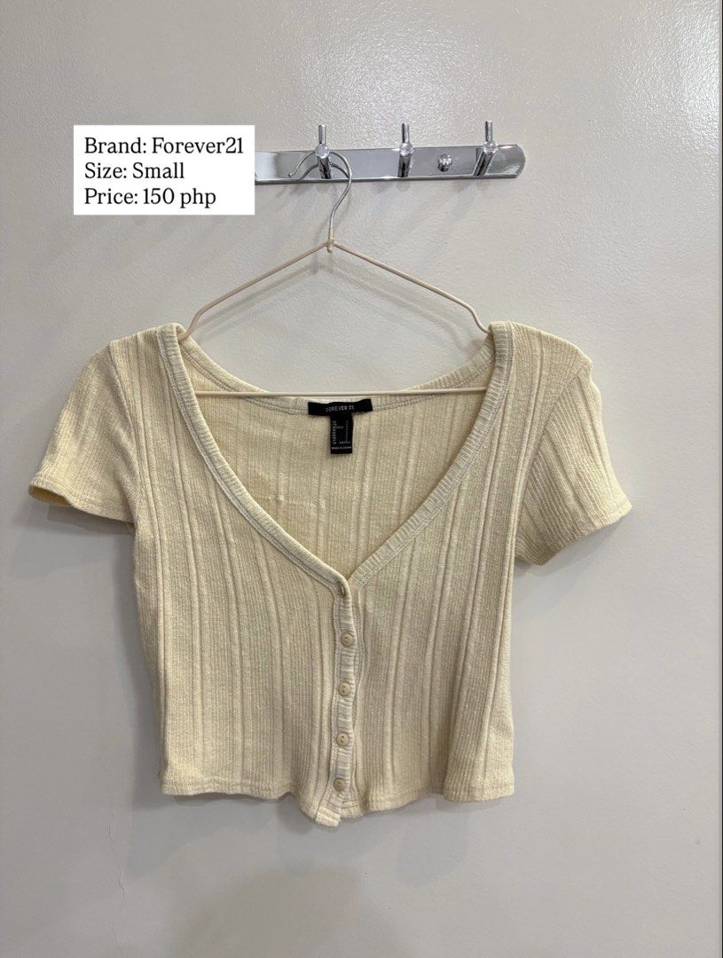 Forever21 Cream Ribbed Button-Down Crop Top Size Small (Category: Blouses) located in Cebu City. Submitted by chinaleah (Listing ID 1469290421, Image 1). Description: - Brand: Forever 21 - Color: Cream - Size: Small (fits true to size) - Material: Soft ribbed knit - Features: Short sleeves, V-neckline, front button closure - Condition: Excellent everyday basic staple.