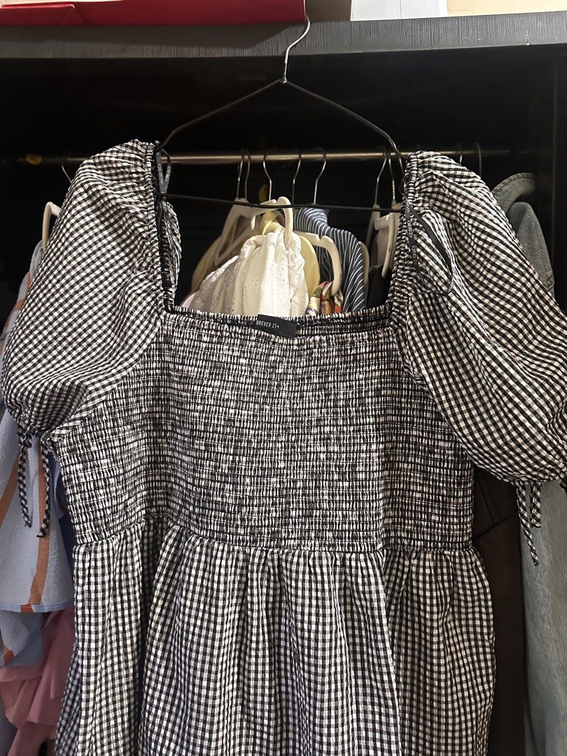 Forever 21 Plus Black White Gingham Dress 3X (Category: Dresses) located in Makati City. Submitted by adorademimay (Listing ID 1469208635, Image 3). Description: - Brand: Forever 21 Plus - Size: 3X - Pattern: Black and white gingham - Material: Super lightweight cotton (great for warm weather) - Design: Square neckline, smocked bodice, and tiered knee-length skirt - Sleeves: Puffy sleeves with cute tie details - Condition: Excellent, no flaws fou