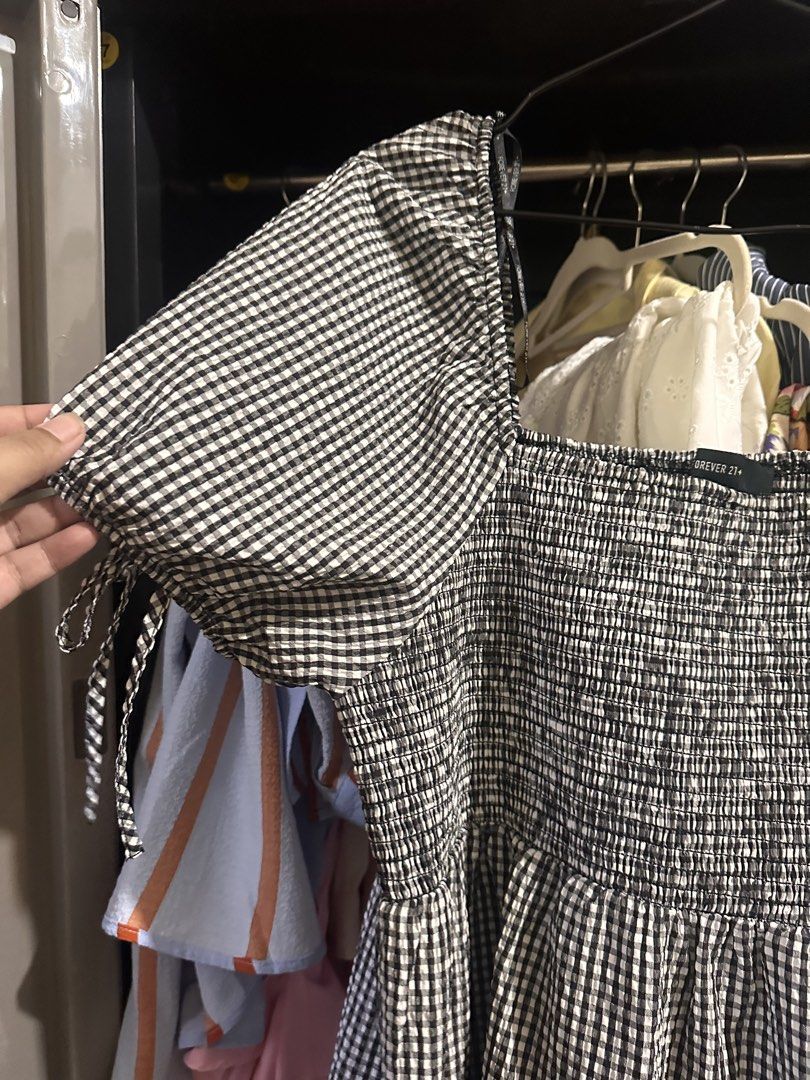 Forever 21 Plus Black White Gingham Dress 3X (Category: Dresses) located in Makati City. Submitted by adorademimay (Listing ID 1469208635, Image 2). Description: - Brand: Forever 21 Plus - Size: 3X - Pattern: Black and white gingham - Material: Super lightweight cotton (great for warm weather) - Design: Square neckline, smocked bodice, and tiered knee-length skirt - Sleeves: Puffy sleeves with cute tie details - Condition: Excellent, no flaws fou