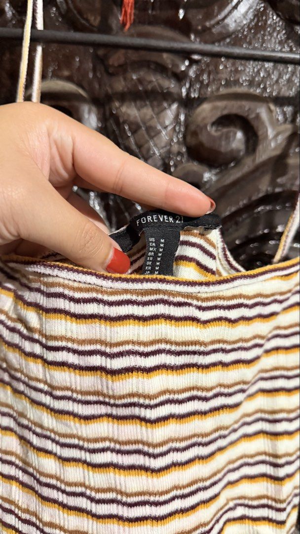 Forever 21 Striped Ribbed Crop Top Size M (Category: Sleeveless) located in Las Pinas. Submitted by aliah2703 (Listing ID 1469173504, Image 2). Description: - Brand: Forever 21 - Style: Ribbed cami crop top with square neckline and spaghetti straps - Pattern: Horizontal stripes (mustard yellow, brown, and white) - Material: Comfortable, stretchy knit fabric - Size: Medium.