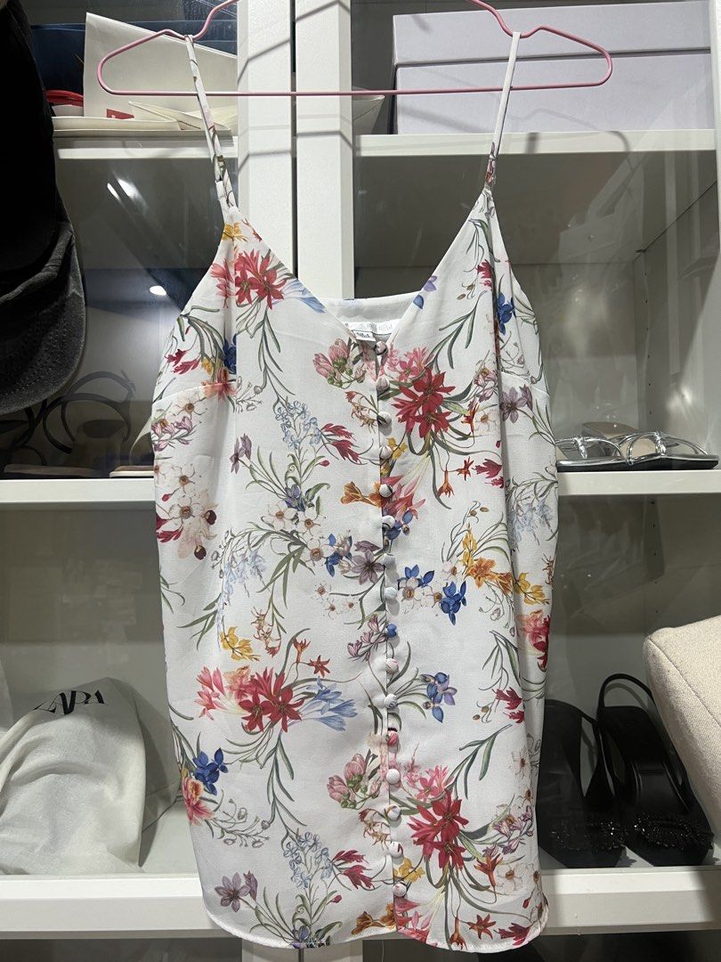 Forever New Floral Cami Top (Category: Sleeveless) located in Taguig. Submitted by strutstella (Listing ID 1469320817, Image 1). Description: - Brand: Forever New - Design: White with all-over floral print, button-front, and V-neck - Straps: Thin and adjustable - Fabric: Lightweight and breathable - Size: AUS 6, EUR 34, USA 2 (Equivalent to UK 6 / US 2 / Extra Small) - Condition: Great for warm weather layering or wearing on its own Up to 34 bust