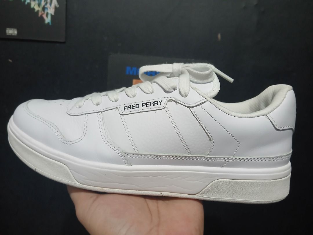 Fred Perry B7325 White Leather Sneakers (Category: Sneakers) located in Caloocan City. Submitted by bqv2020 (Listing ID 1469259944, Image 1). Description: - Brand: Fred Perry - Used tiwice No lint marks - Style: Classic leather court sneakers - Color: White with black heel branding - Size: UK 8 / US 9 / EU 42 - Condition: Clean all around - Inclusion: Original box included.