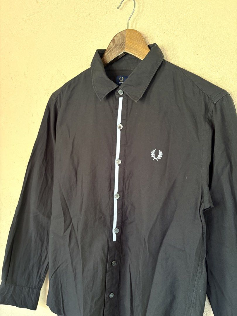 Fred Perry Black Long Sleeve Button Down Shirt Size S (Category: Coats, Jackets and Outerwear) located in Pozorrubio. Submitted by zionegotthrift (Listing ID 1469191901, Image 2). Description: - Brand: Fred Perry - Item: Long Sleeve Shirt - Color: Black with contrast white stripe on button placket - Size: S - Material: 100% cotton (Made in Thailand) - Details: Embroidered laurel wreath logo on left chest - Condition: Clean piece, ideal for smart 