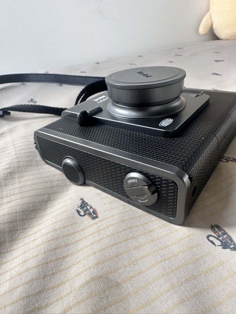 Fujifilm Instax Wide Evo Hybrid Instant Camera (Category: Cameras) located in Quezon City. Submitted by mistercruz (Listing ID 1469317921, Image 3). Description: - Model: Fujifilm Instax Wide Evo Hybrid Instant Camera - Color: Dark Gray with a premium textured body finish - Screen: Large rear LCD screen for digital preview and editing - Features: Fun physical print lever on the side for that classic printing feel - Format: Shoots digitally, choos