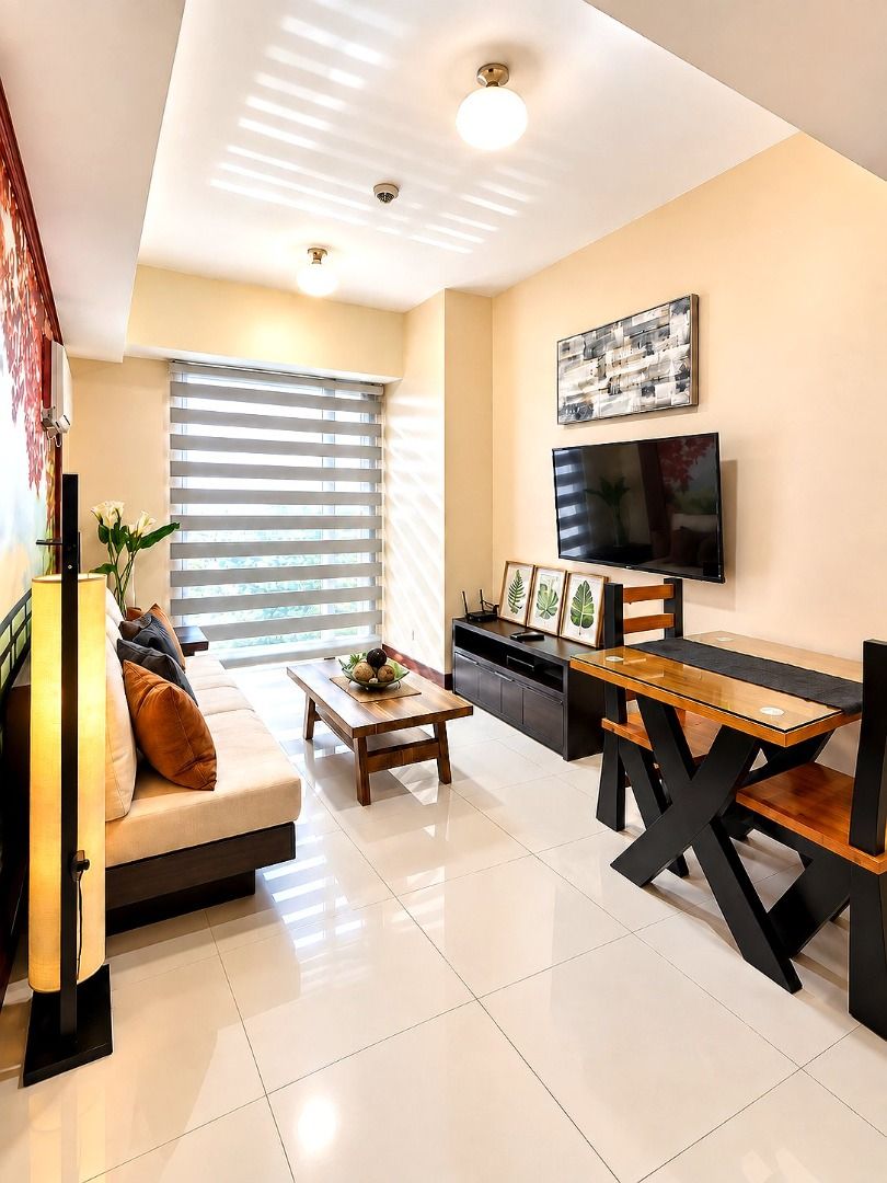 Fully Furnished 1-Bedroom (Category: Apartments & Condos) located in Paranaque City. Submitted by ldcangeli (Listing ID 1469164017, Image 2). Description: - Fully furnished move-in ready unit - Complete living room, bedroom, kitchen, and bathroom - Includes sofa, coffee table, flat screen TV, and dining set - Features a comfortable double bed, refrigerator, and window AC units - Tiled flooring, roller blinds, and warm lighting installed throughou