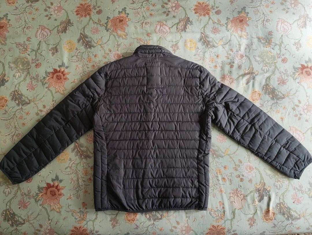 Gap Puffer Jacket (Category: Coats, Jackets and Outerwear) located in Kajang. Submitted by utaniaplants (Listing ID 1469199817, Image 3). Description: - Never used - Color: outside-Dark grey ; inside-Black - Design: All-over quilted pattern with full front zipper and high collar - Pockets: Two spacious side pockets for keys or phone - Comfort: Lightweight warmth, perfect for layering over sweaters - Condition: New & never used, clean inside and o