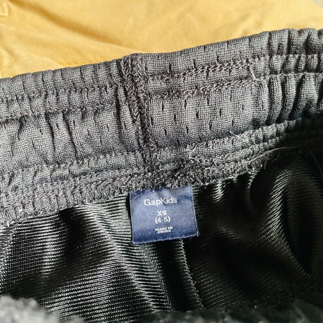 GapKids Varsity Athletic Mesh Shorts (Category: Babies & Kids Fashion) located in Caloocan City. Submitted by lovemyclothes21 (Listing ID 1469271810, Image 3). Description: - Brand: GapKids - Size: XS (fits ages 4-5 years old) - Color: Black with grey side panels and white drawstring - Design: Varsity Athletic graphic print near the hem - Material: Breathable, lightweight fabric - Fit: Easy pull-on style with comfortable elastic waistband - Condi
