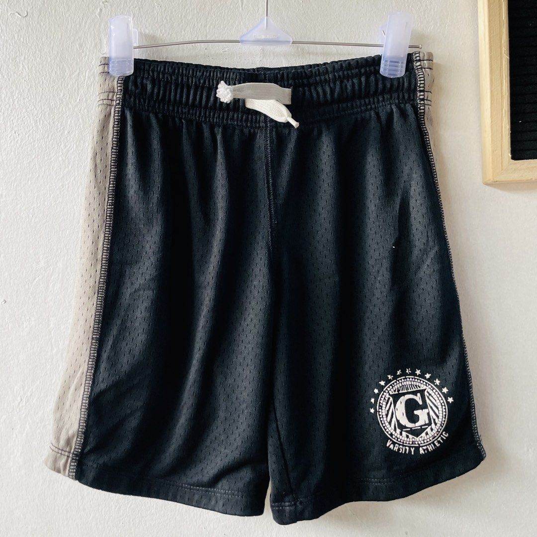 GapKids Varsity Athletic Mesh Shorts (Category: Babies & Kids Fashion) located in Caloocan City. Submitted by lovemyclothes21 (Listing ID 1469271810, Image 2). Description: - Brand: GapKids - Size: XS (fits ages 4-5 years old) - Color: Black with grey side panels and white drawstring - Design: Varsity Athletic graphic print near the hem - Material: Breathable, lightweight fabric - Fit: Easy pull-on style with comfortable elastic waistband - Condi