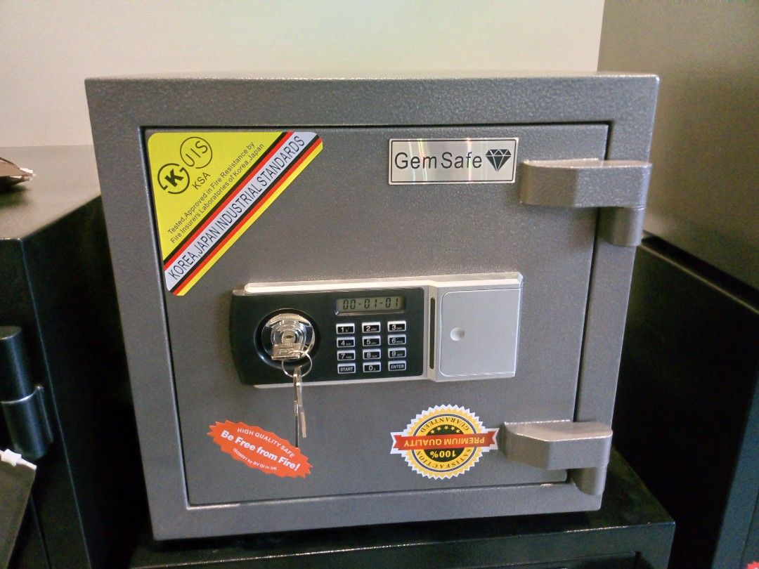 Gem Safe Digital Electronic Safe Box with Keys and Batteries (Category: Safe) located in Manila. Submitted by online_tindako (Listing ID 1469194567, Image 1). Description: - Brand: Gem Safe Digital Electronic Safe Box - Finish: Durable gray hammer-tone finish - Security: Electronic keypad with digital display and override key lock (backup keys included) - Interior: Removable shelf to organize your storage space - Build: Heavy-duty steel construct