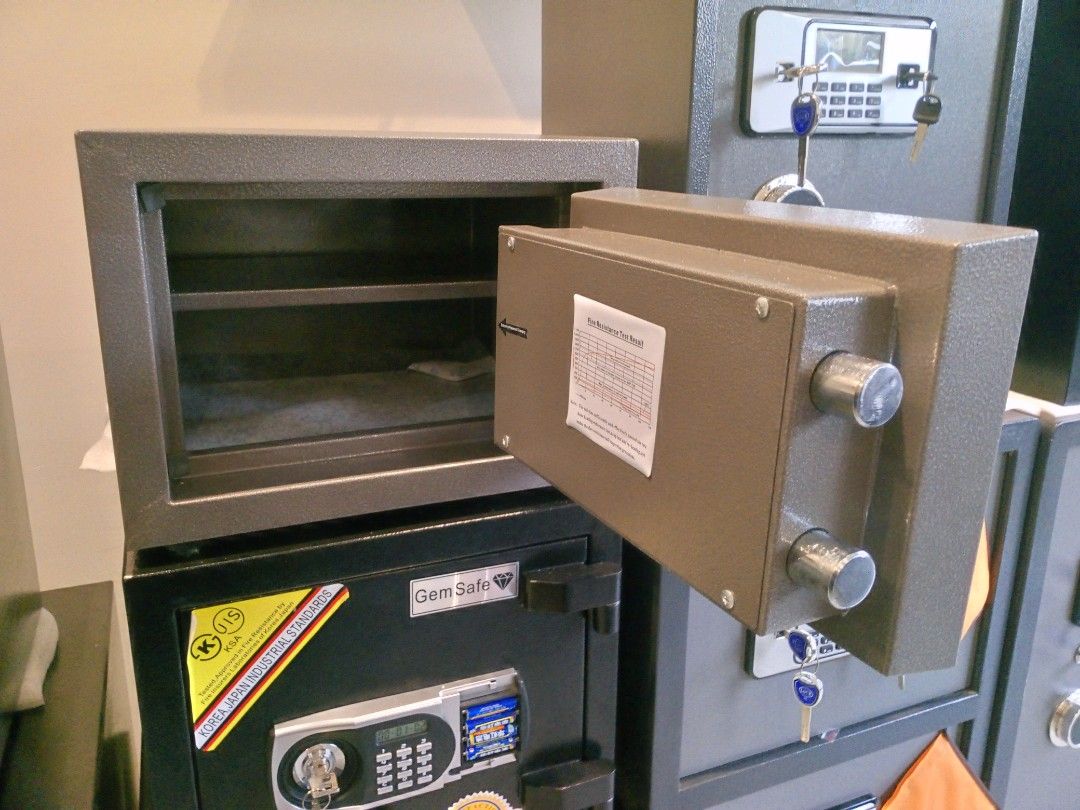 Gem Safe Digital Electronic Safe Box with Keypad (Category: Safe) located in Manila. Submitted by online_tindako (Listing ID 1469197205, Image 2). Description: - Brand/Model: Gem Safe digital security box - Color: Dark grey - Security: Digital keypad with LED display, override key lock, and two solid steel locking bolts - Interior: Clean felt lining with a removable shelf - Features: Fire resistance test label and physical keys included - Power: 