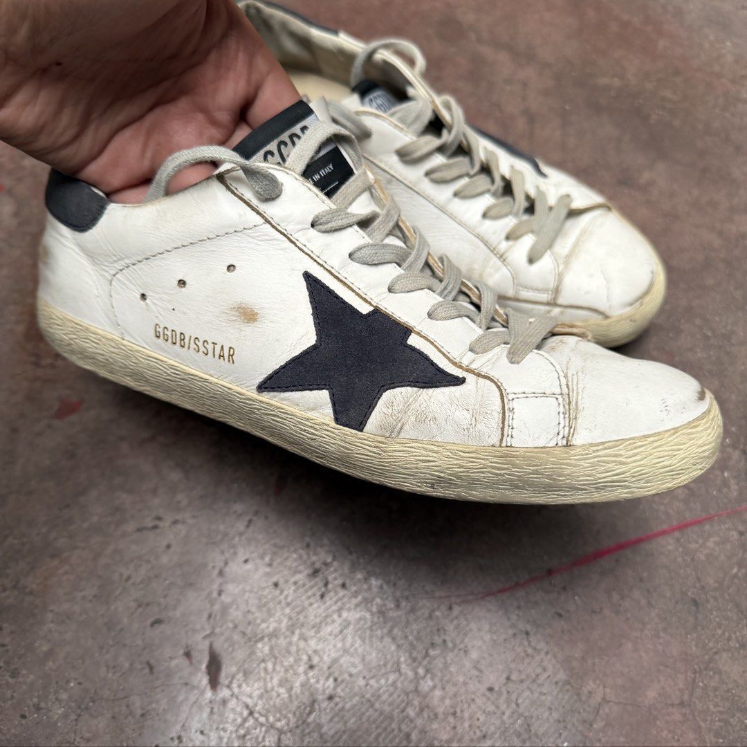 Original GGDB Golden Goose Superstar Size EU41 (Category: Sneakers) located in Manila. Submitted by mr_buysell (Listing ID 1468884876, Image 1). Description: 100% original - Passed Authentication by POIZON GGDB Golden Goose Superstar Suede Dark Blue Tab & Star Size EU41 - 26-26.5cm (Fits to US 9 Mens) Issue: Outsole cracks Sampaloc Manila area.