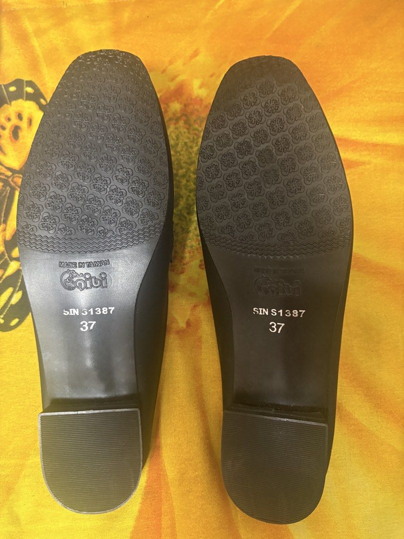 Gibi Black Mules With Chain Detail Size 37 (Category: Flats & Sandals) located in Manila. Submitted by nykji96 (Listing ID 1469179538, Image 2). Description: - Brand: Gibi - Style: Slip-on mules with low block heel and square toe - Details: Chic black and gold chain accent across the front - Size: 37 (marked on sole) - Origin: Made in Taiwan (Style No. SIN S1387) - Condition: Clean insoles and textured outer soles for good grip.