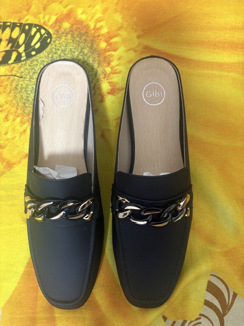 Gibi Black Mules With Chain Detail Size 37 (Category: Flats & Sandals) located in Manila. Submitted by nykji96 (Listing ID 1469179538, Image 1). Description: - Brand: Gibi - Style: Slip-on mules with low block heel and square toe - Details: Chic black and gold chain accent across the front - Size: 37 (marked on sole) - Origin: Made in Taiwan (Style No. SIN S1387) - Condition: Clean insoles and textured outer soles for good grip.