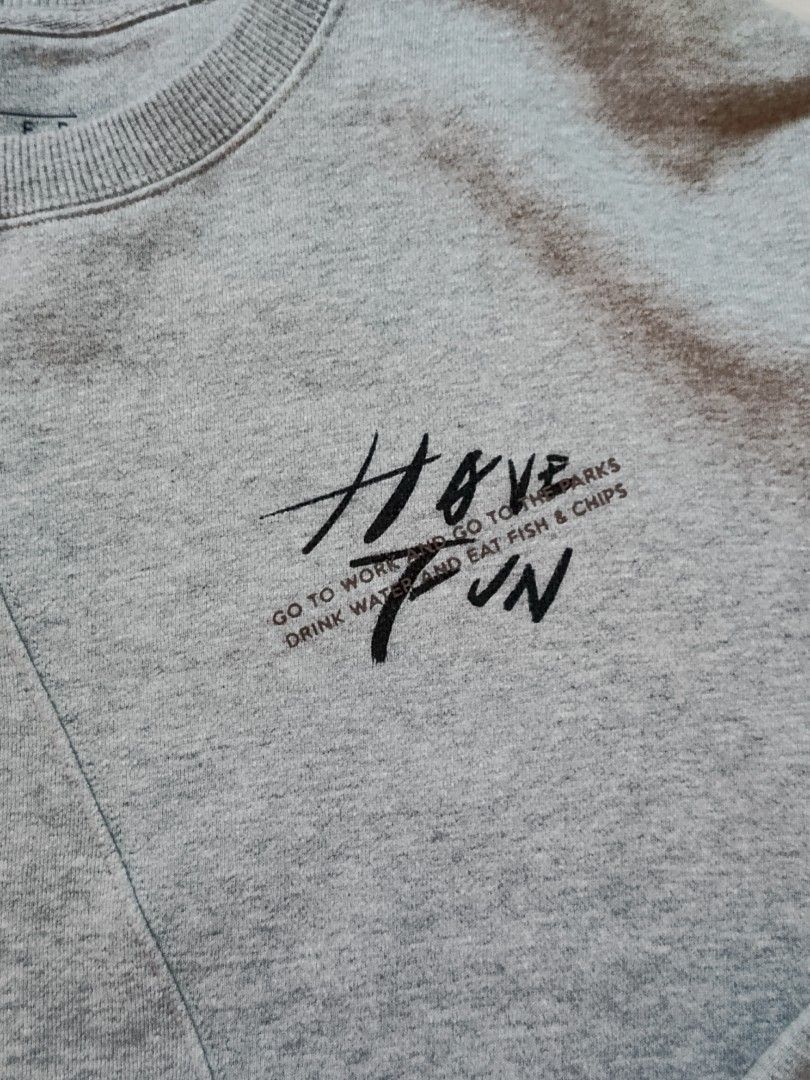 Ginger Grey Graphic Sweatshirt Size L (Category: Coats, Jackets and Outerwear) located in Cabatuan. Submitted by penthegreat (Listing ID 1469176591, Image 2). Description: dimes: 22x26 - Brand/Model: Ginger grey sweatshirt - Size: L - Design: 'HAVE FUN' chest print with trendy angled front panel stitching - Details: Ribbed collar, cuffs, and hem for a snug fit - Material: Warm and cozy cotton blend - Condition/Use: Great casual pullover for every