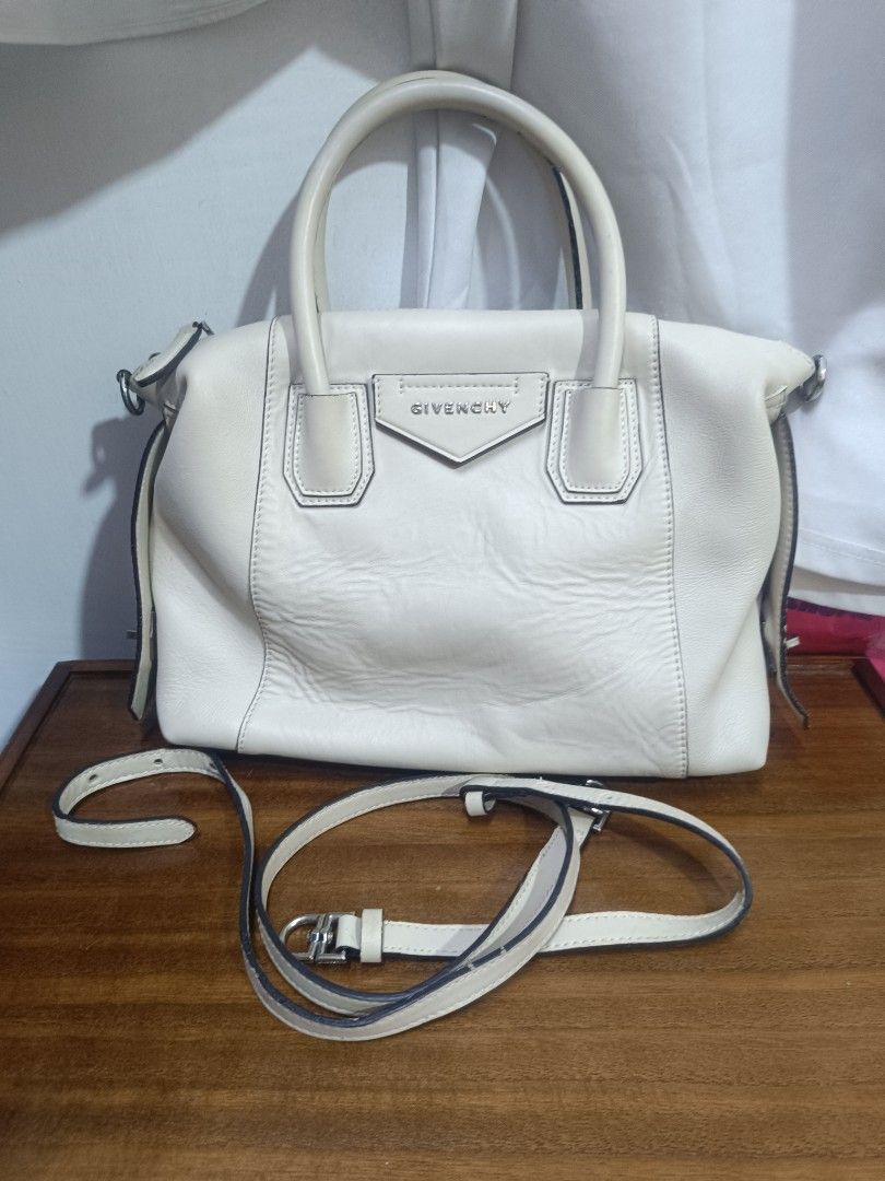Givenchy Antigona White Leather Handbag (Category: Luxury Bags & Wallets) located in Pateros City. Submitted by harry062182 (Listing ID 1469198579, Image 1). Description: - Brand: Givenchy Antigona Satchel - Color: Classic White in smooth leather - Hardware: Silver-tone with top zip closure - Interior: Clean fabric lining with embossed 'Made in Italy' leather patch and serial number tag (GF 0271) - Strap: Includes adjustable and detachable matchi