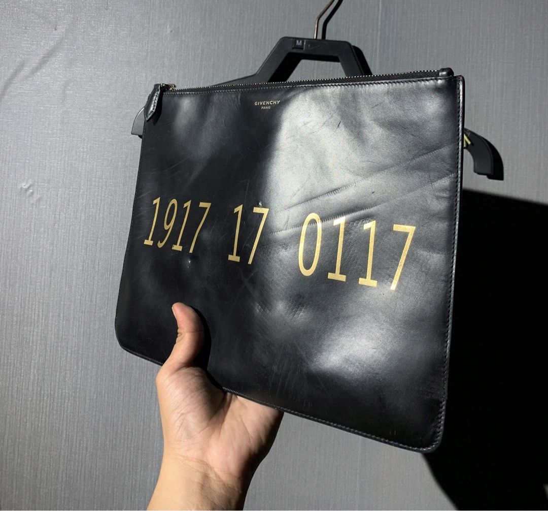 givenchy clutch/ pouch (Category: Luxury Bags & Wallets) located in Bacolod City. Submitted by garagehunterbuyandsale (Listing ID 1469309376, Image 1). Description: Givenchy 1917 Printed Leather Pouch in Black issue scratchesss take a look before u buy.