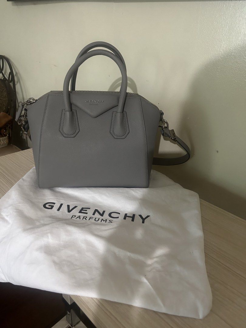 Givenchy Parfums Grey Handbag with Dust Bag (Category: Luxury Bags & Wallets) located in Cebu City. Submitted by serene_simplicity (Listing ID 1469392609, Image 1). Description: - Brand: Givenchy Parfums - Material: Premium grey pebbled leather with silver-tone hardware - Closure: Secure top-zip closure - Straps: Dual top handles and a detachable, adjustable shoulder strap - Interior: Light-colored fabric lining with multiple pockets for organiza