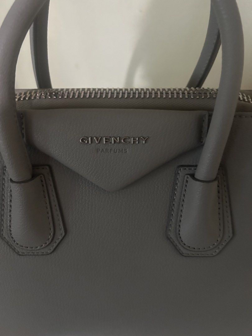 Givenchy Parfums Grey Handbag with Dust Bag (Category: Luxury Bags & Wallets) located in Cebu City. Submitted by serene_simplicity (Listing ID 1469392609, Image 2). Description: - Brand: Givenchy Parfums - Material: Premium grey pebbled leather with silver-tone hardware - Closure: Secure top-zip closure - Straps: Dual top handles and a detachable, adjustable shoulder strap - Interior: Light-colored fabric lining with multiple pockets for organiza