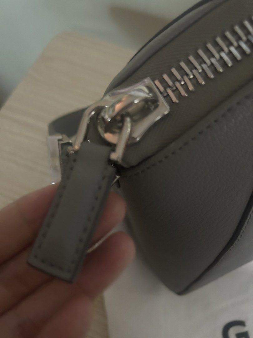 Givenchy Parfums Grey Handbag with Dust Bag (Category: Luxury Bags & Wallets) located in Cebu City. Submitted by serene_simplicity (Listing ID 1469392609, Image 3). Description: - Brand: Givenchy Parfums - Material: Premium grey pebbled leather with silver-tone hardware - Closure: Secure top-zip closure - Straps: Dual top handles and a detachable, adjustable shoulder strap - Interior: Light-colored fabric lining with multiple pockets for organiza
